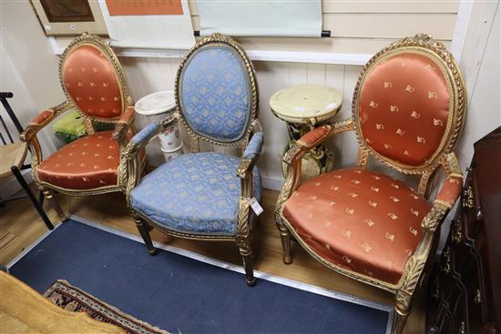A set of three Louis XV style carved giltwood fauteuils, one with differing upholstery